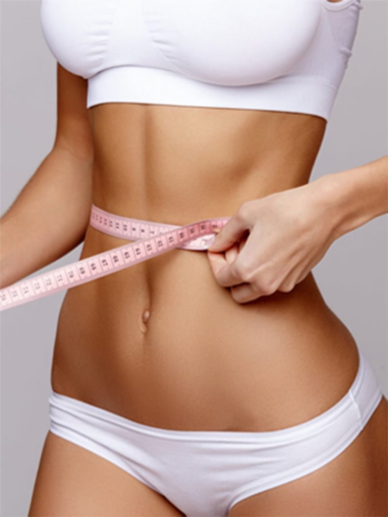 Woman holding a tape measure around waist